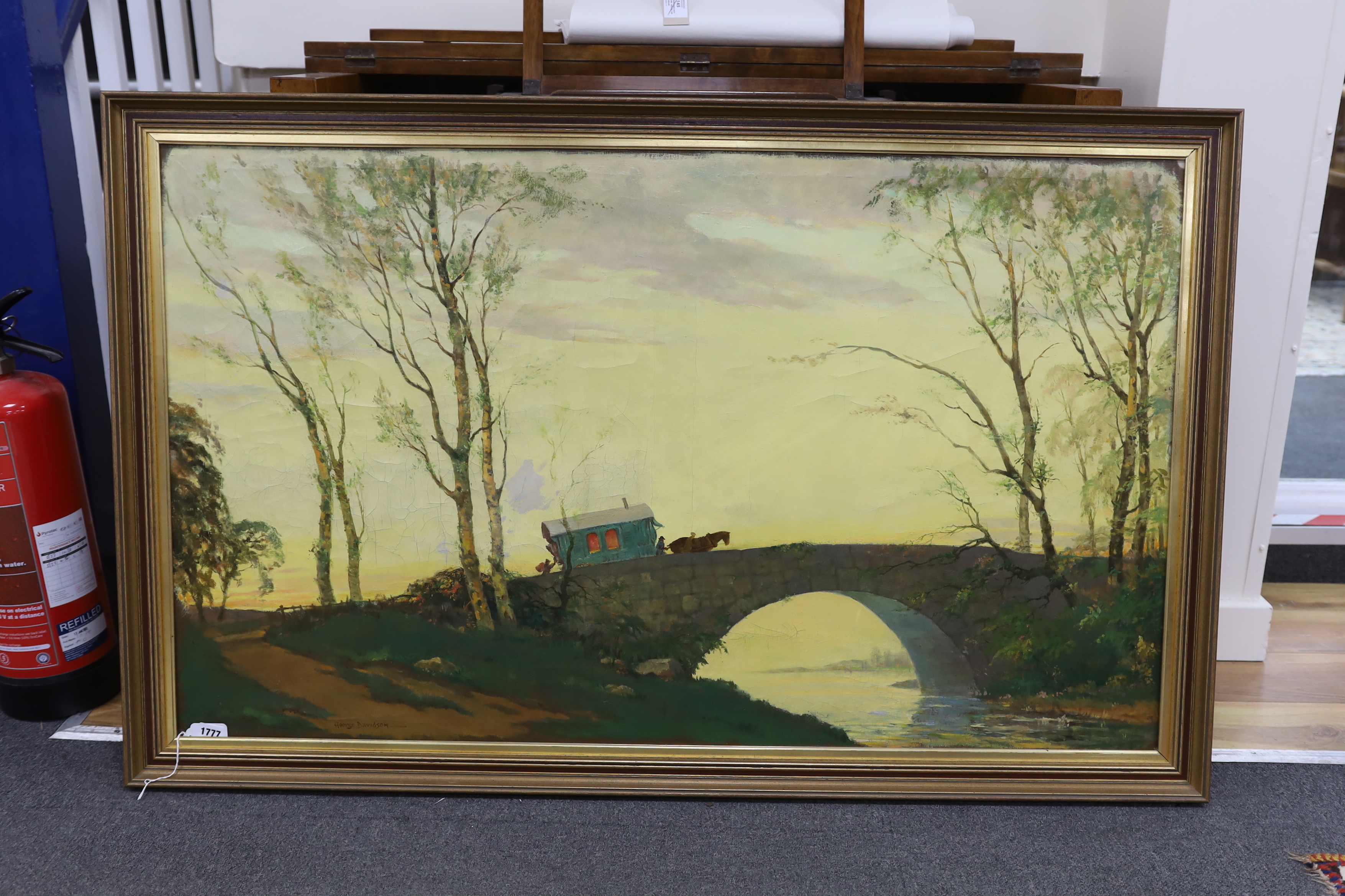 George Davidson (Polish/American, 1889-1965), naive oil on canvas, Gypsy wagon and figures crossing a bridge, signed, 74 x 124cm